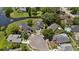 An aerial shot highlights the property's proximity to waterfront views and mature trees within the community at 1748 Harvest Cv, Winter Park, FL 32792