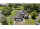 A beautifully landscaped home boasts a private backyard bordering a tranquil waterway in an aerial view at 1748 Harvest Cv, Winter Park, FL 32792