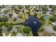 An aerial perspective shows the property's placement beside a scenic pond with a fountain, surrounded by homes at 1748 Harvest Cv, Winter Park, FL 32792