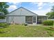 Expansive backyard showcasing the home's exterior, patio, and manicured lawn at 1748 Harvest Cv, Winter Park, FL 32792