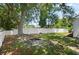 Spacious backyard featuring a fire pit, lush lawn, and mature trees at 1748 Harvest Cv, Winter Park, FL 32792
