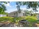 Backyard showcasing lush greenery and mature palm trees at 1748 Harvest Cv, Winter Park, FL 32792