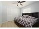 Charming bedroom with built-in headboard, drawers, closet, ceiling fan, and wood floors at 1748 Harvest Cv, Winter Park, FL 32792
