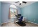 Cozy bedroom with a large window, ceiling fan, and a computer setup at 1748 Harvest Cv, Winter Park, FL 32792