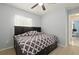 Charming bedroom with built-in headboard, drawers, closet, ceiling fan, and wood floors at 1748 Harvest Cv, Winter Park, FL 32792