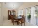 Classic dining room featuring a wooden table, chairs, hutch and chandelier with natural light from sliding glass door at 1748 Harvest Cv, Winter Park, FL 32792