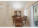 Classic dining room featuring a wooden table, chairs, hutch and chandelier with natural light from sliding glass door at 1748 Harvest Cv, Winter Park, FL 32792