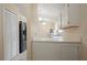 Bright kitchen features pendant lighting, white cabinets, modern appliances, and ample counter space at 1748 Harvest Cv, Winter Park, FL 32792