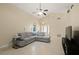 Bright and airy living room featuring tile flooring, vaulted ceiling, and a comfortable sectional sofa at 1748 Harvest Cv, Winter Park, FL 32792