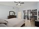Spacious main bedroom featuring vaulted ceiling, fan, shoe rack, and sliding glass doors at 1748 Harvest Cv, Winter Park, FL 32792