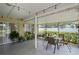 Inviting screened-in patio with dining area and view of the backyard at 1748 Harvest Cv, Winter Park, FL 32792
