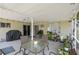Inviting covered patio with dining area, grill, and serene outdoor ambiance at 1748 Harvest Cv, Winter Park, FL 32792