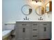 Modern bathroom with double vanity and stylish round mirrors at 1825 Foxhall Cir # 1825, Kissimmee, FL 34741