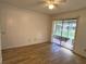 Bright bedroom with wood floors, and sliding door access to the outdoors at 1825 Foxhall Cir # 1825, Kissimmee, FL 34741