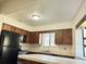 Functional kitchen with a breakfast bar, ample counter space, and black appliances at 1825 Foxhall Cir # 1825, Kissimmee, FL 34741