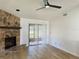 Spacious living room features a stone fireplace and sliding glass doors at 1825 Foxhall Cir # 1825, Kissimmee, FL 34741