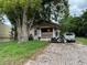 Charming home featuring a cozy porch, brick driveway, and mature trees enhancing curb appeal at 1996 Indiana Ave, Winter Park, FL 32789