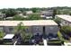 This aerial view shows a townhome community, landscaping and fenced backyard patios at 200 Saint Andrews Blvd # 3002, Winter Park, FL 32792