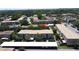 This aerial view shows the townhome community, landscaping, parking and nearby road at 200 Saint Andrews Blvd # 3002, Winter Park, FL 32792