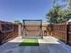 Backyard features putting green and tall wooden privacy fence at 200 Saint Andrews Blvd # 3002, Winter Park, FL 32792