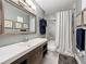Updated bathroom features a modern vanity, marble countertop, framed art, and tiled shower with glass doors at 200 Saint Andrews Blvd # 3002, Winter Park, FL 32792