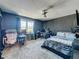 Unique bedroom with soundproofing wall texture, ceiling fan, carpeting, and home office at 200 Saint Andrews Blvd # 3002, Winter Park, FL 32792