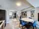 Open concept dining room showcasing a modern table and chairs and a view into the kitchen at 200 Saint Andrews Blvd # 3002, Winter Park, FL 32792