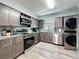 Well-equipped kitchen with stainless steel appliances and gray cabinets at 200 Saint Andrews Blvd # 3002, Winter Park, FL 32792