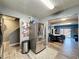 Bright kitchen with stainless steel refrigerator, and view into the dining area at 200 Saint Andrews Blvd # 3002, Winter Park, FL 32792