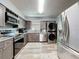 Modern kitchen featuring stainless steel washer/dryer combo and updated cabinetry at 200 Saint Andrews Blvd # 3002, Winter Park, FL 32792