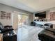 Comfortable living room with modern gray walls, gray flooring, a large TV and access to the backyard at 200 Saint Andrews Blvd # 3002, Winter Park, FL 32792