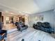 Spacious living room with gray walls and gray flooring, adjacent to the dining area and kitchen at 200 Saint Andrews Blvd # 3002, Winter Park, FL 32792