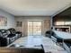 Comfortable living room with modern gray walls, gray flooring, a large TV and access to the backyard at 200 Saint Andrews Blvd # 3002, Winter Park, FL 32792