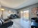Cozy living room featuring gray walls, gray flooring, comfortable seating, and natural light from sliding glass door at 200 Saint Andrews Blvd # 3002, Winter Park, FL 32792