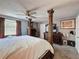 This bedroom features a four-poster bed, carpet floors, a ceiling fan and windows at 200 Saint Andrews Blvd # 3002, Winter Park, FL 32792