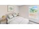 Inviting bedroom featuring soft, neutral decor, natural light from a window, and a comfortable bed with patterned bedding at 2140 Hibiscus Pl, Kissimmee, FL 34759