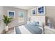 Cozy bedroom with a white and blue bed and blue accents, brightened with lots of natural light at 2140 Hibiscus Pl, Kissimmee, FL 34759
