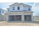 Unfinished two-story home featuring a two car garage and an unfinished front yard at 2649 Great Heron Ave, St Cloud, FL 34773