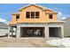 Unfinished two-story home featuring a two car garage and an unfinished front yard at 2649 Great Heron Ave, St Cloud, FL 34773