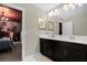 Bright bathroom with dual sinks and view into a themed bedroom at 2927 Fable St, Kissimmee, FL 34746