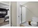 Bathroom with glass shower, toilet and view into the bedroom at 2927 Fable St, Kissimmee, FL 34746