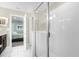 Modern bathroom features tiled floors, a glass-enclosed shower, and access to an adjacent bedroom at 2927 Fable St, Kissimmee, FL 34746