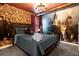 Themed bedroom with red ceiling, stone wall and a large mural behind the bed at 2927 Fable St, Kissimmee, FL 34746