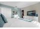 Bright bedroom with a white comforter set, white furniture, and gray-blue walls at 2927 Fable St, Kissimmee, FL 34746