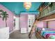 Bedroom with tiki bunk bed, turquoise ceiling, and playful mural exudes vacation fun at 2927 Fable St, Kissimmee, FL 34746