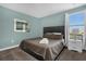 Standard bedroom with a dark bed frame, window, bedside table and a piece of artwork at 2927 Fable St, Kissimmee, FL 34746