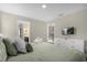 Bedroom featuring green patterned bedding, two doors, and a television at 2927 Fable St, Kissimmee, FL 34746