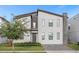 Modern two-story home featuring a stone accent wall, gray trim, and a paver driveway at 2927 Fable St, Kissimmee, FL 34746