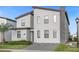 Modern two-story home with a stone chimney, paver driveway, and manicured landscaping at 2927 Fable St, Kissimmee, FL 34746