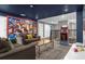 Spacious game room with themed decor, comfortable seating, and an arcade game at 2927 Fable St, Kissimmee, FL 34746